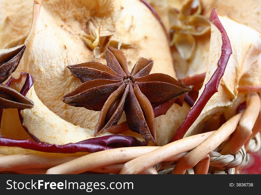 Dried apples and anise star in a basket. Dried apples and anise star in a basket