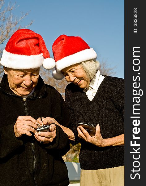 Grandma is showing Grandpa how to enter data into their new handheld computers. Grandma is showing Grandpa how to enter data into their new handheld computers.