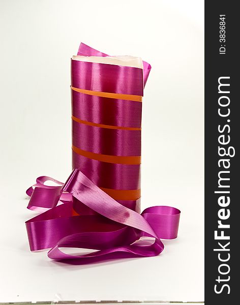 A purple candle with ribbon.