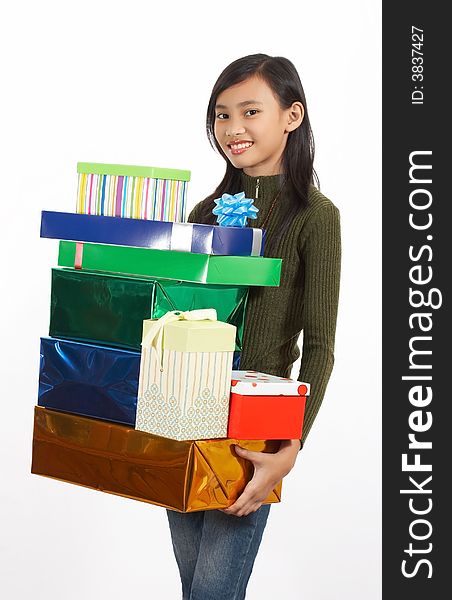 A girl holding a bunch of christmas gift