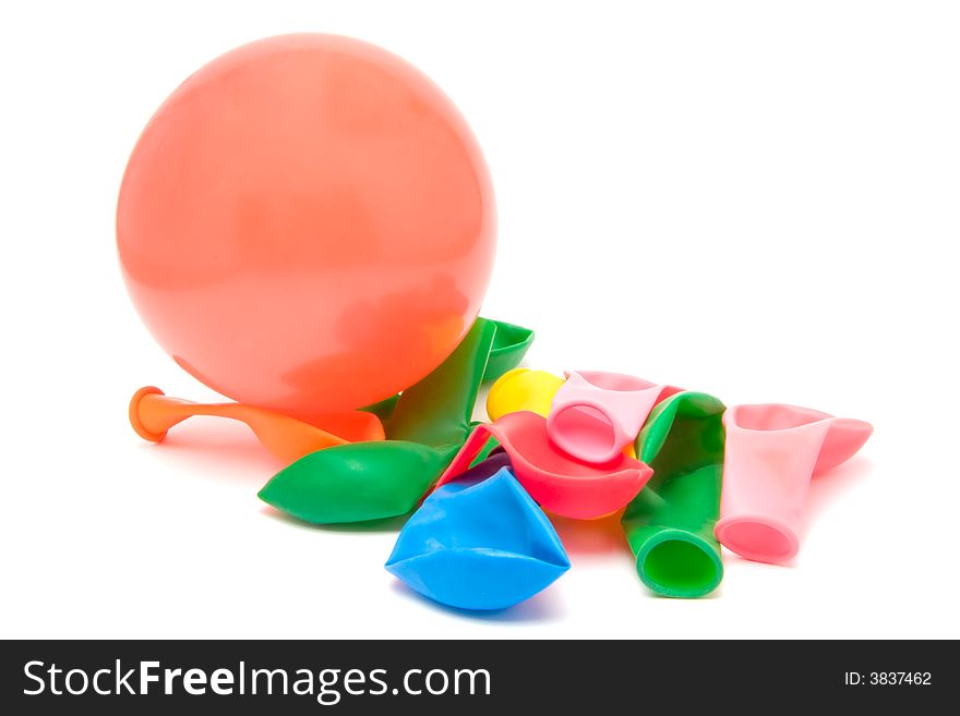 Closeup of a pile of deflated balloons and one inflated