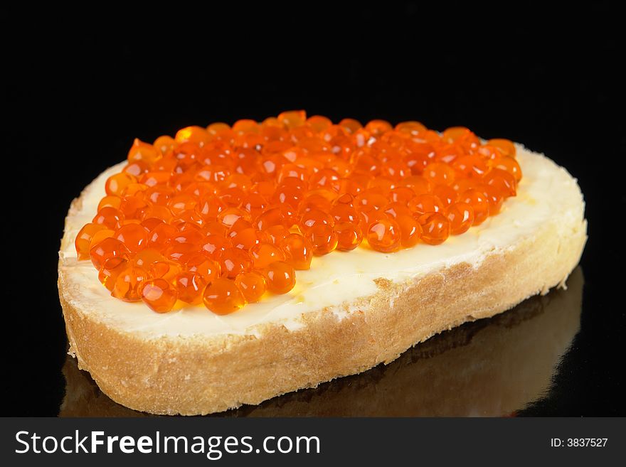 Red caviar on a black background