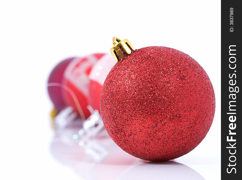 Red christmas balls over a white background