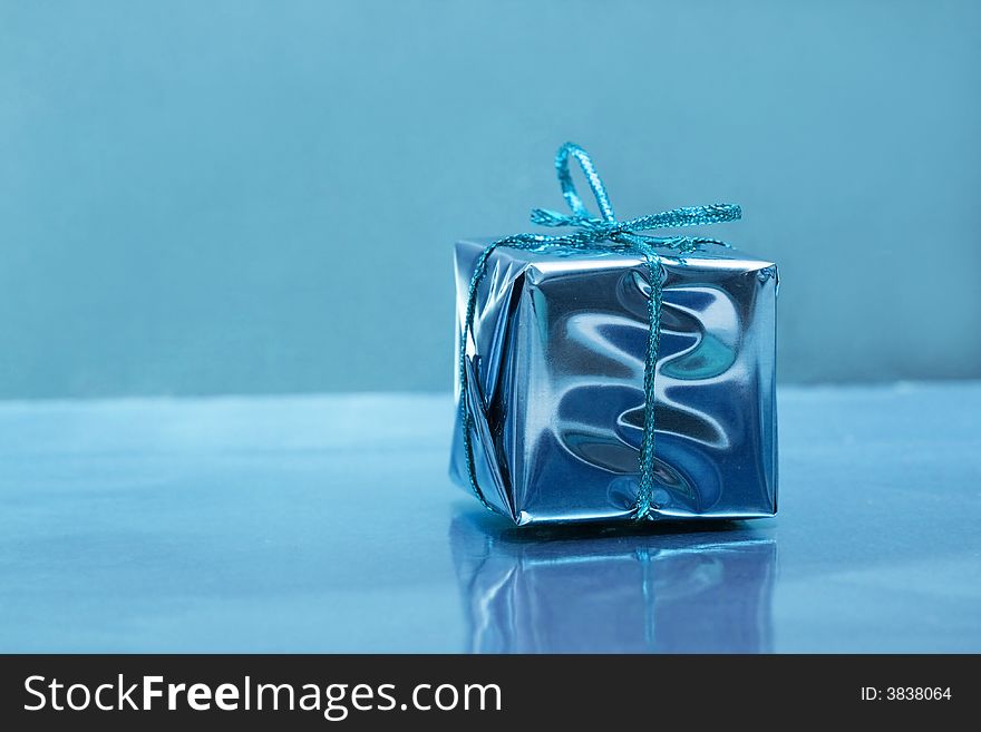 One gift small box on blue background