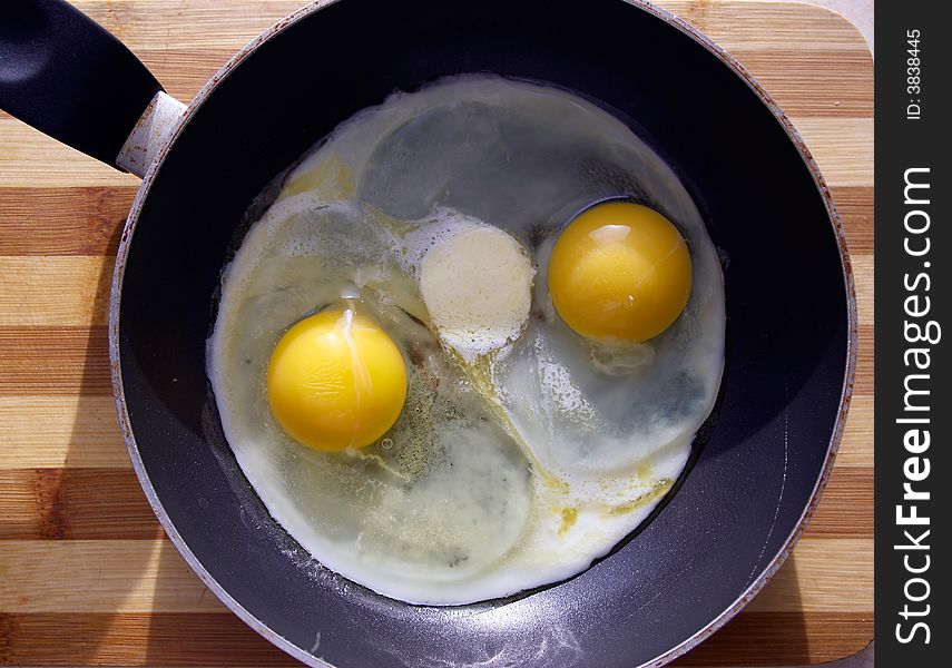 Ready fried eggs lays on a frying pan. Ready fried eggs lays on a frying pan