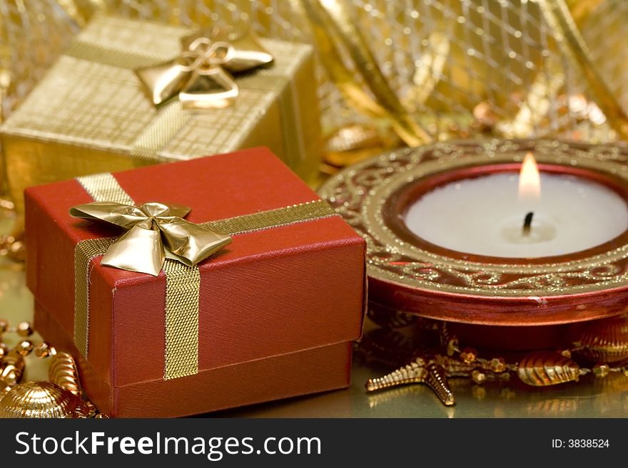 Gift boxes and burning candle
