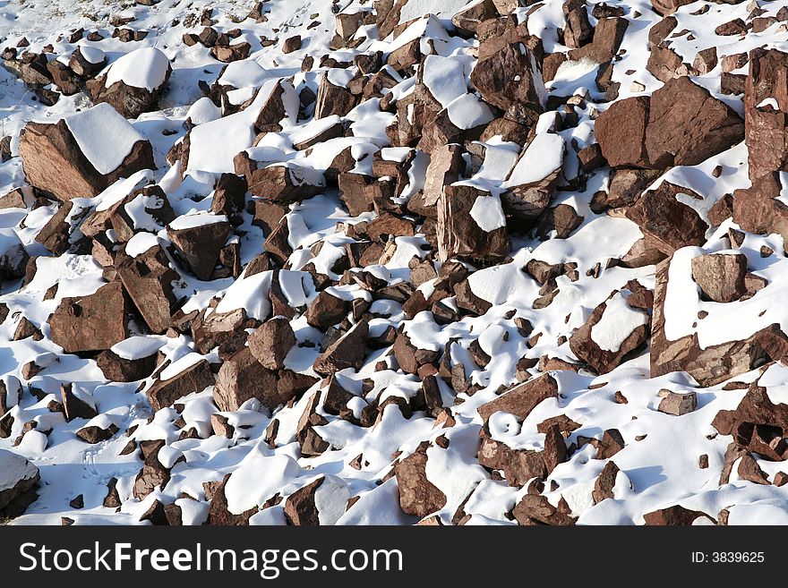 Stones covered snow