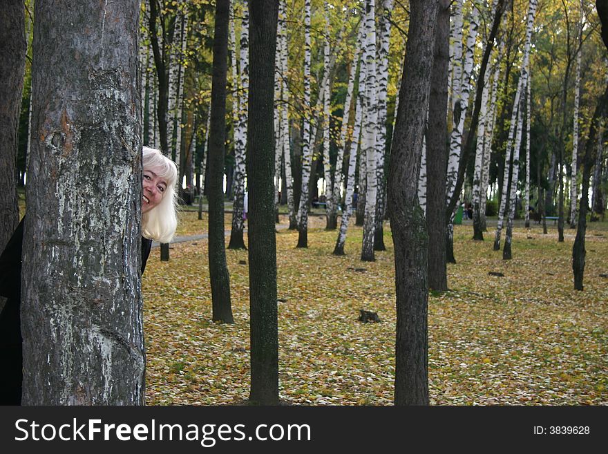 The woman in park in the autumn