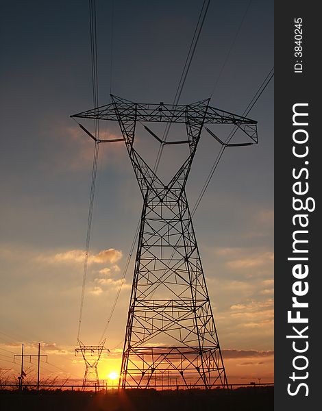 Electric power transmission towers at sunset. Electric power transmission towers at sunset