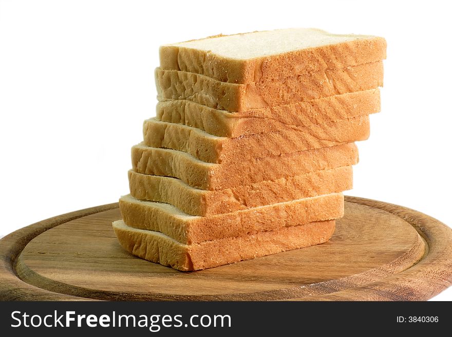 Pile of toast on a wooden kitchen board in white background