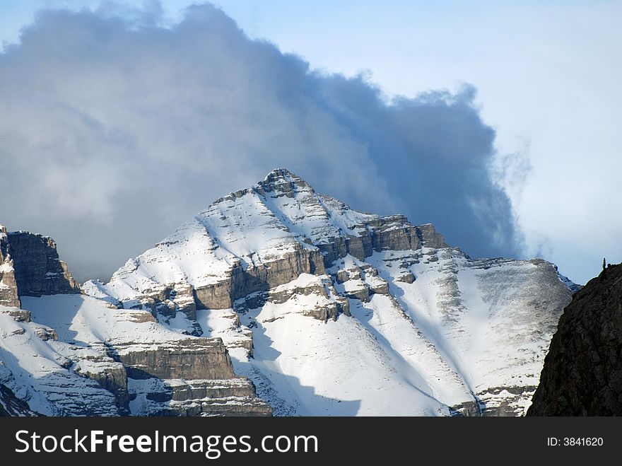 Storm cloud behind a mountaintop in Banff, Canada. Storm cloud behind a mountaintop in Banff, Canada.