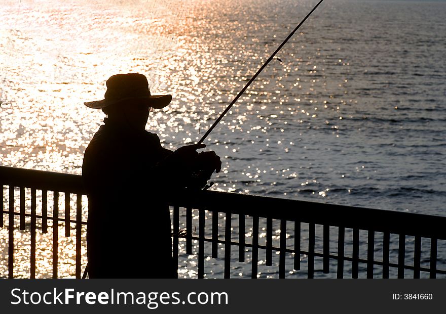 Silhouette image of a fisherman in early morning