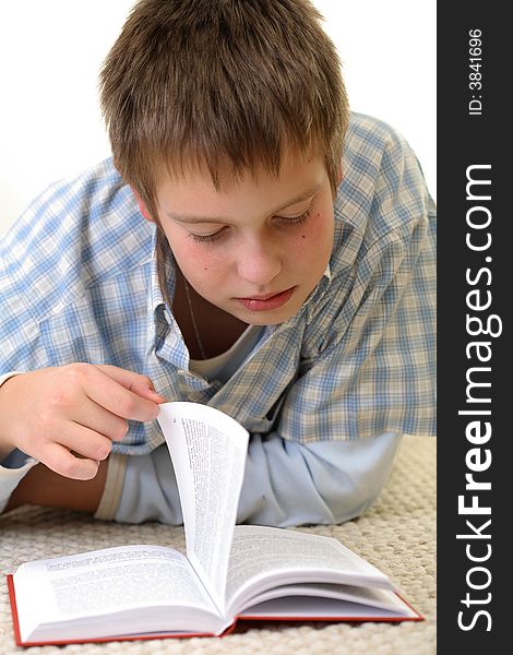 Young Boy learning on the floor