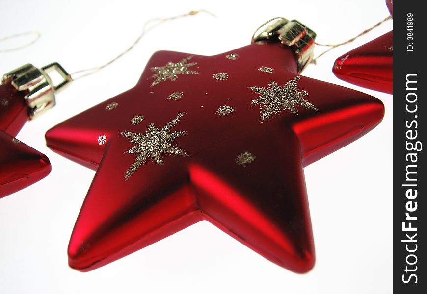 A red Christmas Star sparkling on a white background. A red Christmas Star sparkling on a white background