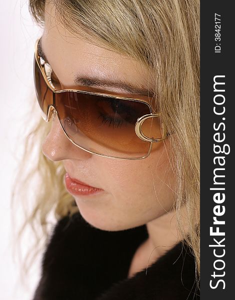 Shot of a serious blonde headshot modeling glasses