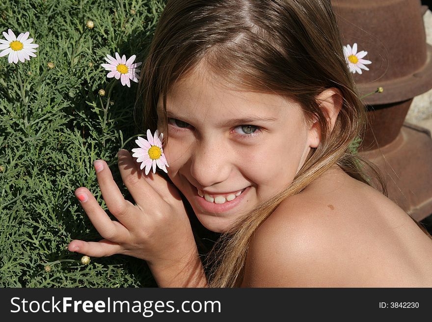 Little girl posing with flowers from her garden. Little girl posing with flowers from her garden