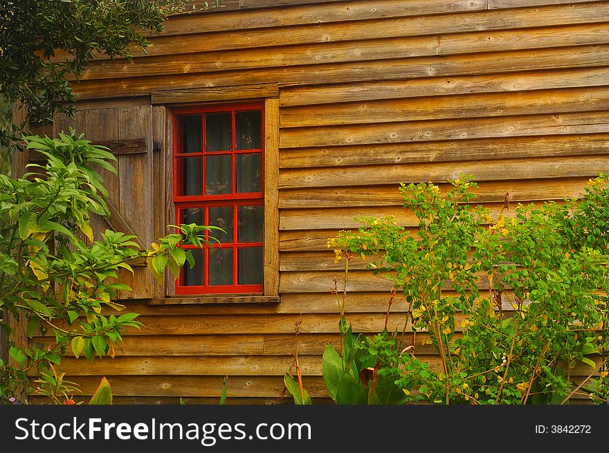 Image of one red window on vintage southern home. Image of one red window on vintage southern home