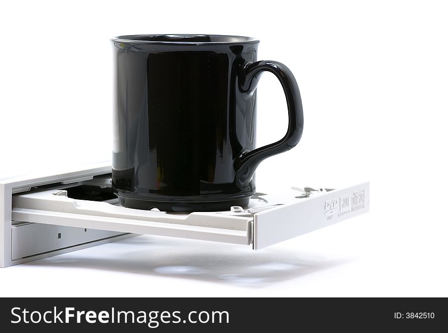 Coffee cup on a dvd player on white background. Coffee cup on a dvd player on white background