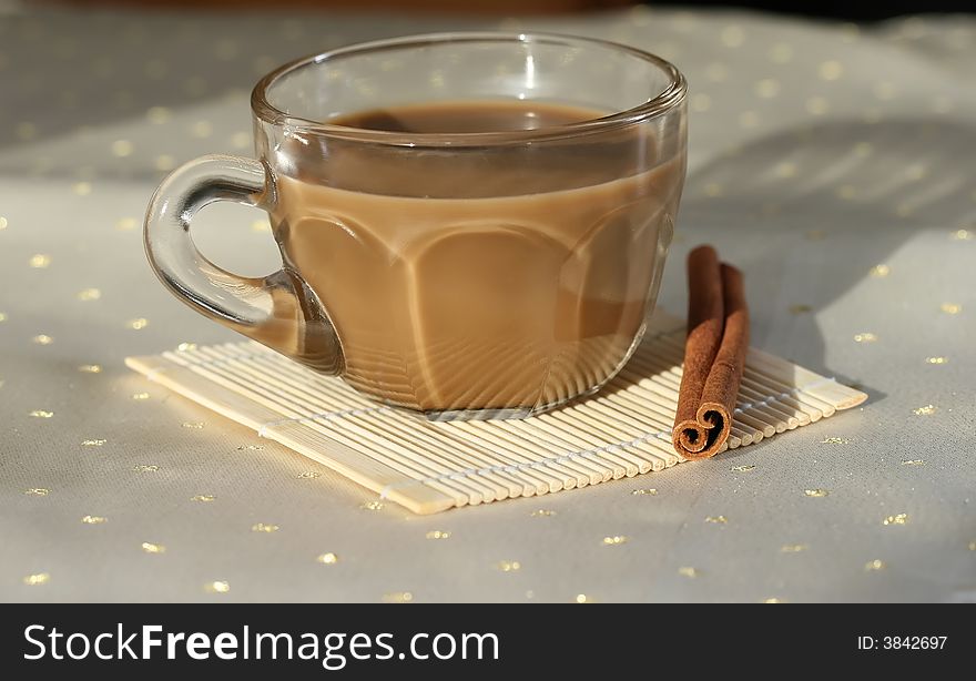 A cup of coffee with a cinnamon stick
