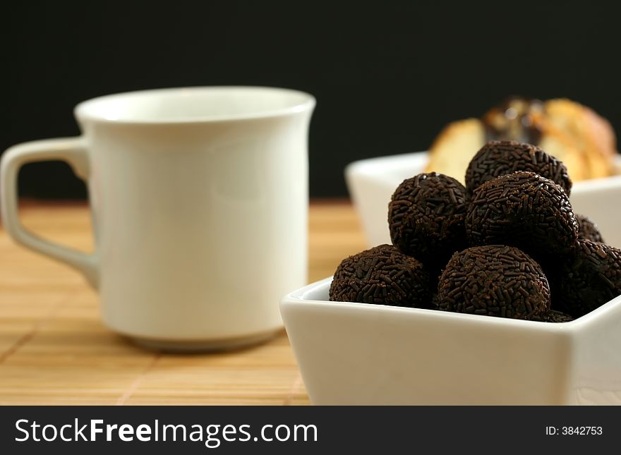 Coffee and chocolate for dessert with a black background. Coffee and chocolate for dessert with a black background