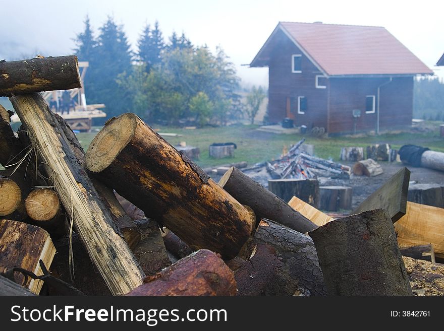 A closeup of fire logs outside cabin in the countryside.