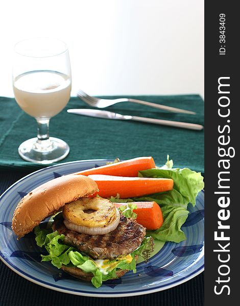 Healthier homemade grilled burger with carrots and plenty vegetables