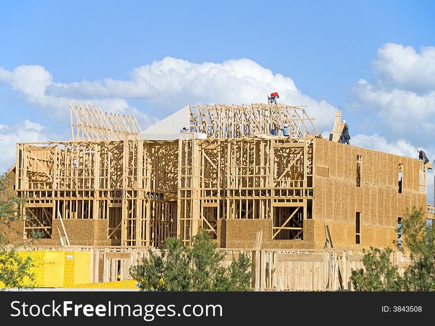 Two story frame condos under construction showing green wood on first floor and construction slab. Two story frame condos under construction showing green wood on first floor and construction slab