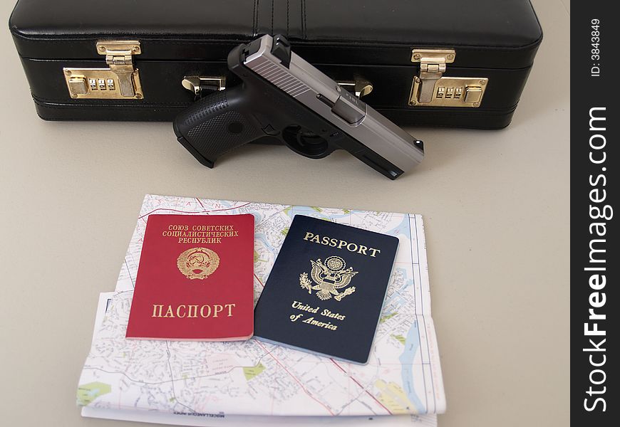 Soviet passport and Usa passport
 with handgun and case. Soviet passport and Usa passport
 with handgun and case