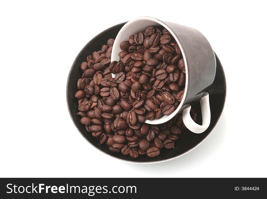 The black cup with fragrant coffee costs on a table