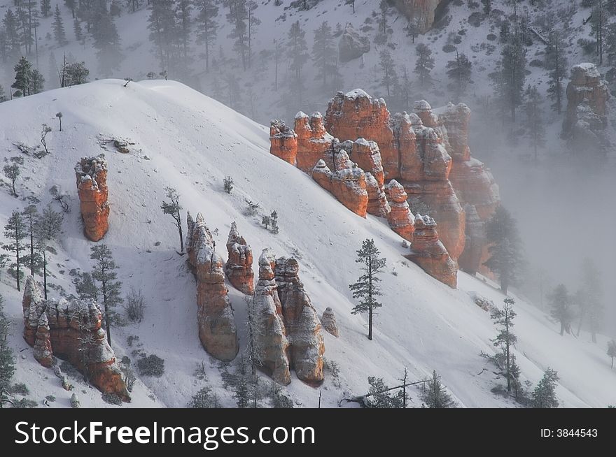 Hoodoos in fog and covered in snow after snow storm. Hoodoos in fog and covered in snow after snow storm.