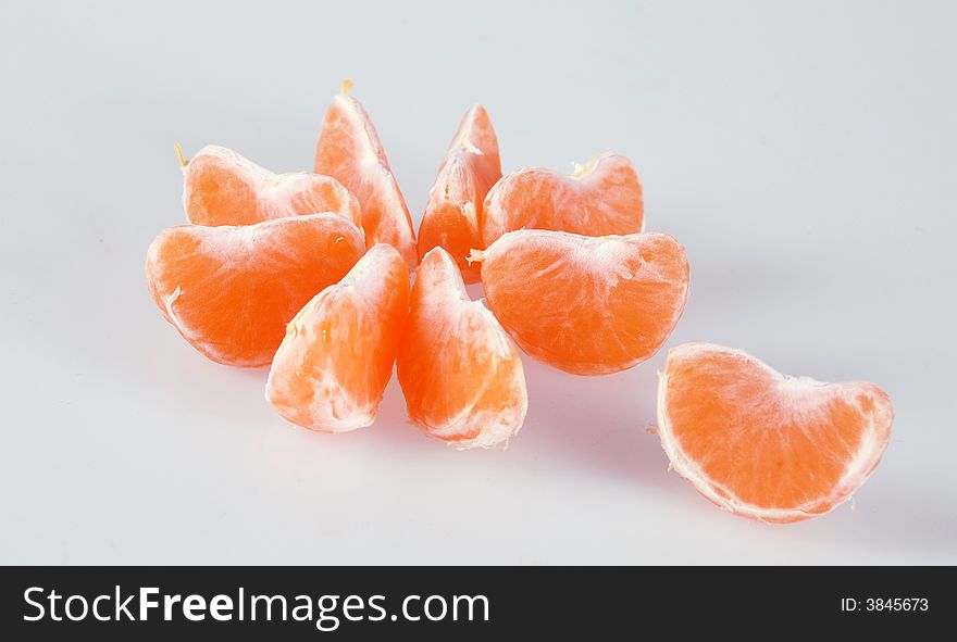 Slices of tangerine on white background