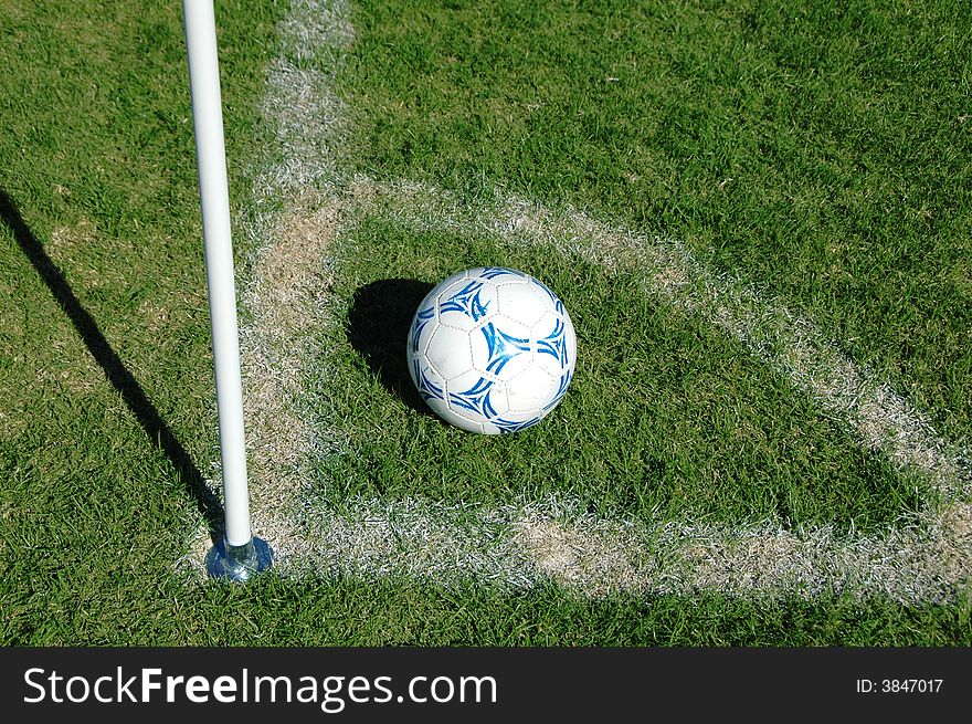 Soccer ball in the corner on a sunny day