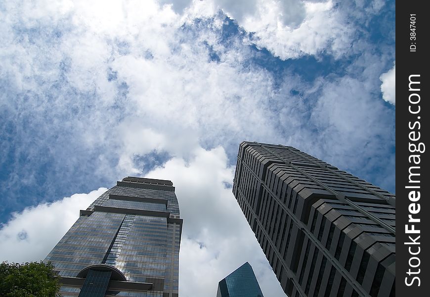 Towering skyscrapers rising into a cloudy stormy sky. Towering skyscrapers rising into a cloudy stormy sky