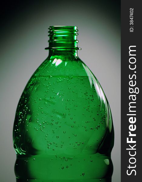 Green plastic bottle with water