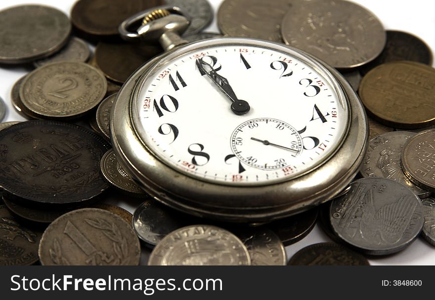 Old pocket watch on the coins of different countries. Old pocket watch on the coins of different countries