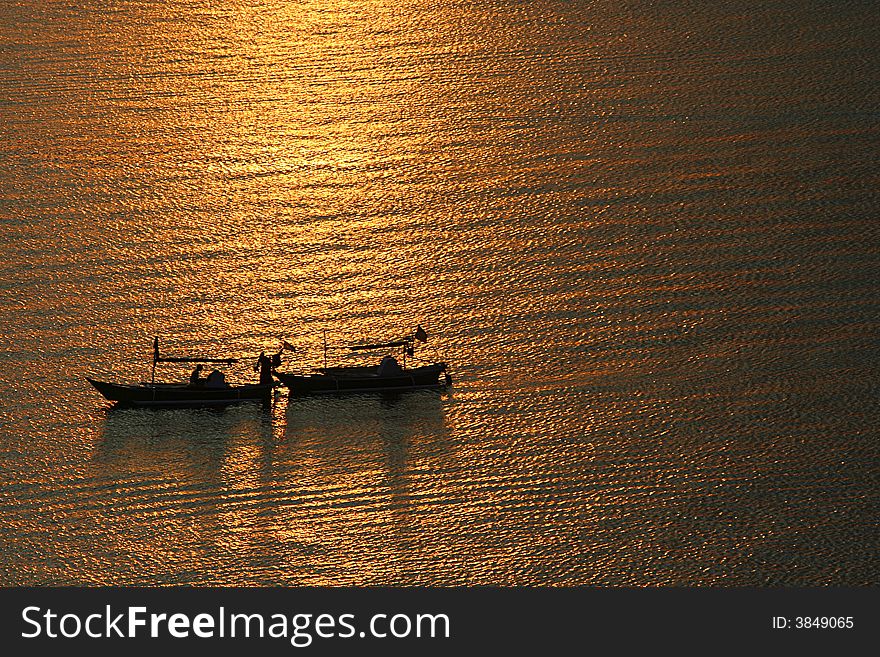 Two boats on golden light