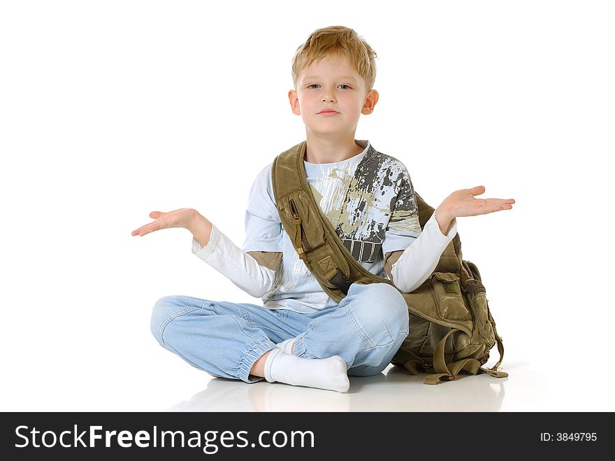 Young schoolboy with bag gesturing with hands; isolated on white background.
