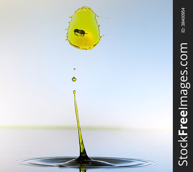 Splashing water drops on color background.Color waterdrops collide each other.