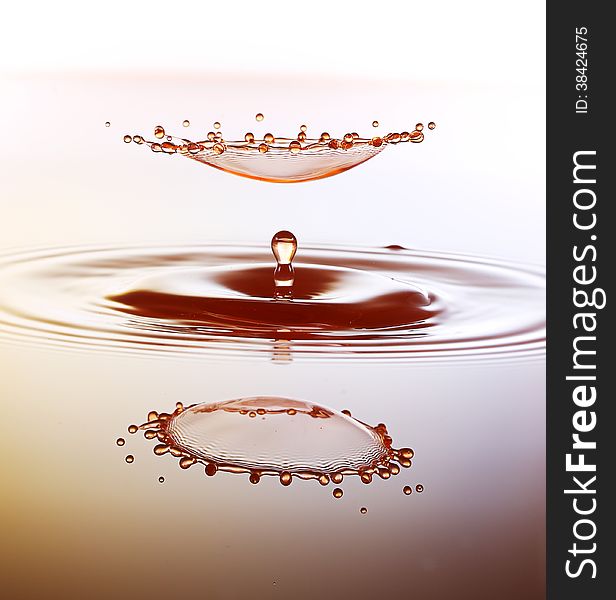 Splashing water drops on color background.Color waterdrops collide each other.