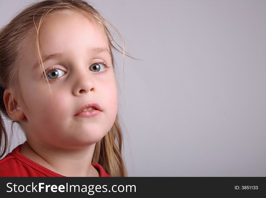 Face of young girl  on the gray background