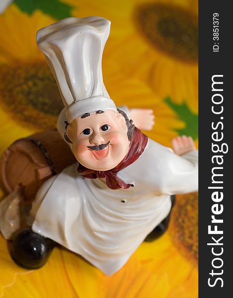 Figurine of the cook on the background