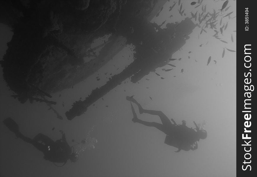 2 divers at heavy gun 105mm at stern of Thistlegorm, Red Sea, Egypt. 2 divers at heavy gun 105mm at stern of Thistlegorm, Red Sea, Egypt