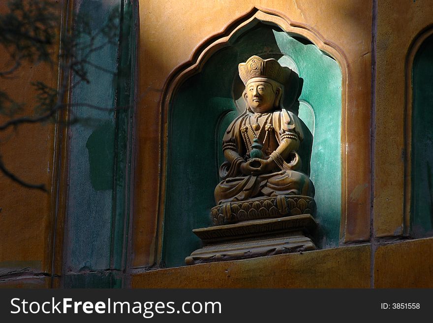 A beam of light illuminates the image of a Buddha on the Pavilion of the Fragrance of Buddha The Summer Palace (Yiheyuan), Beijing, China. A beam of light illuminates the image of a Buddha on the Pavilion of the Fragrance of Buddha The Summer Palace (Yiheyuan), Beijing, China