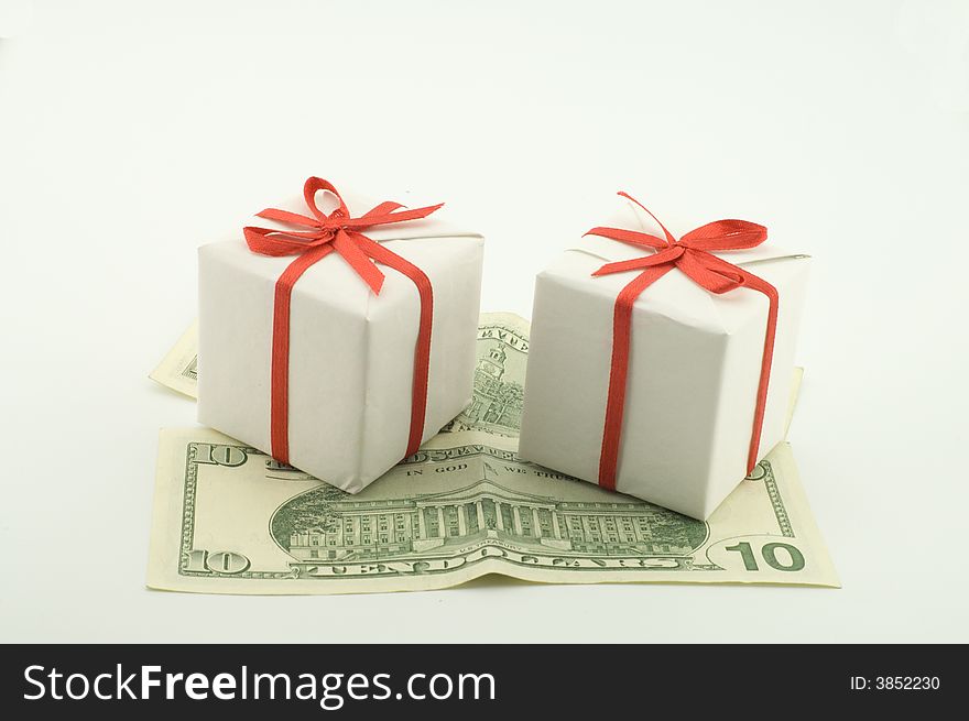 Small white boxes with gifts on dollar denominations. Small white boxes with gifts on dollar denominations