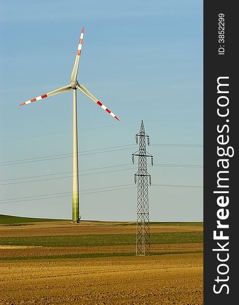 Windmill and power pole on the horizon. Windmill and power pole on the horizon