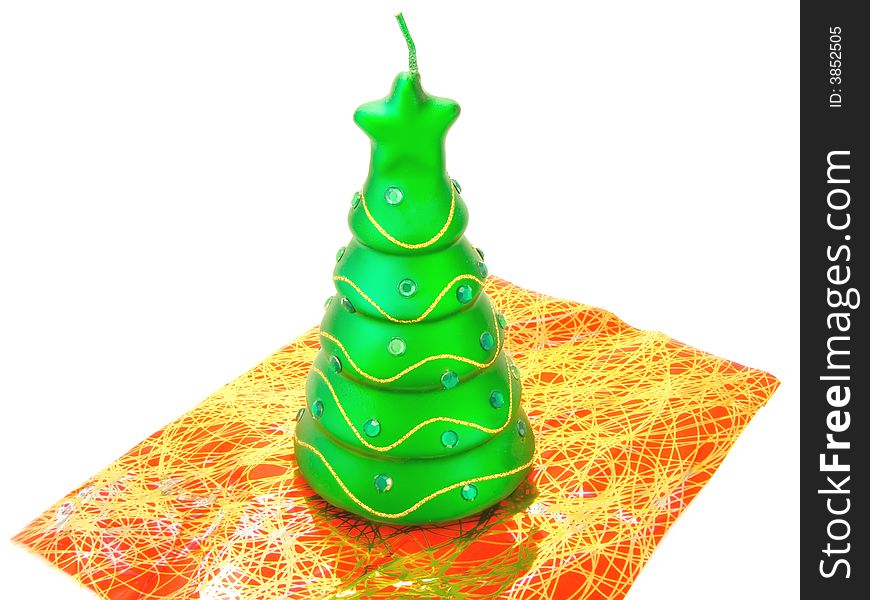 New-year candle in form the decorated fir-tree on a white background. New-year candle in form the decorated fir-tree on a white background