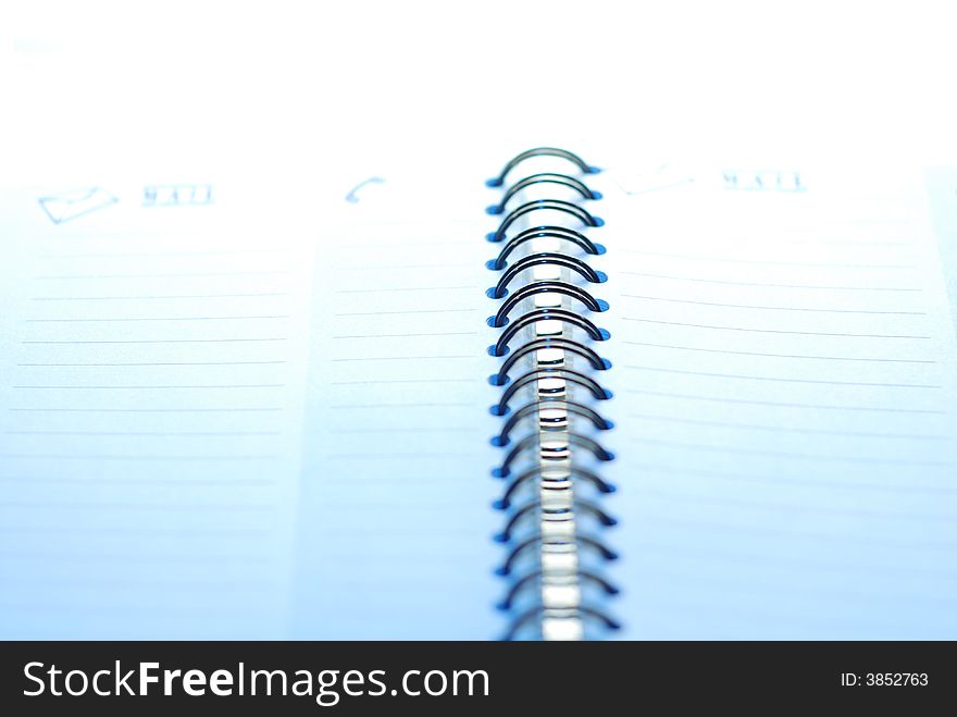 A small spiral notebook. background