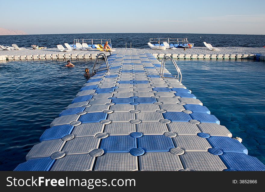 Pontoon bridge with open water swiming pool under coral reef in red sea resort. Pontoon bridge with open water swiming pool under coral reef in red sea resort