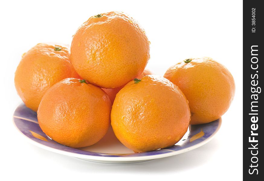 Tangerines on a plate on white background