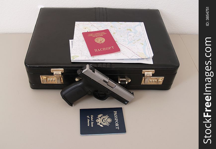 Two passports and suitcase with map and gun for special agent 007